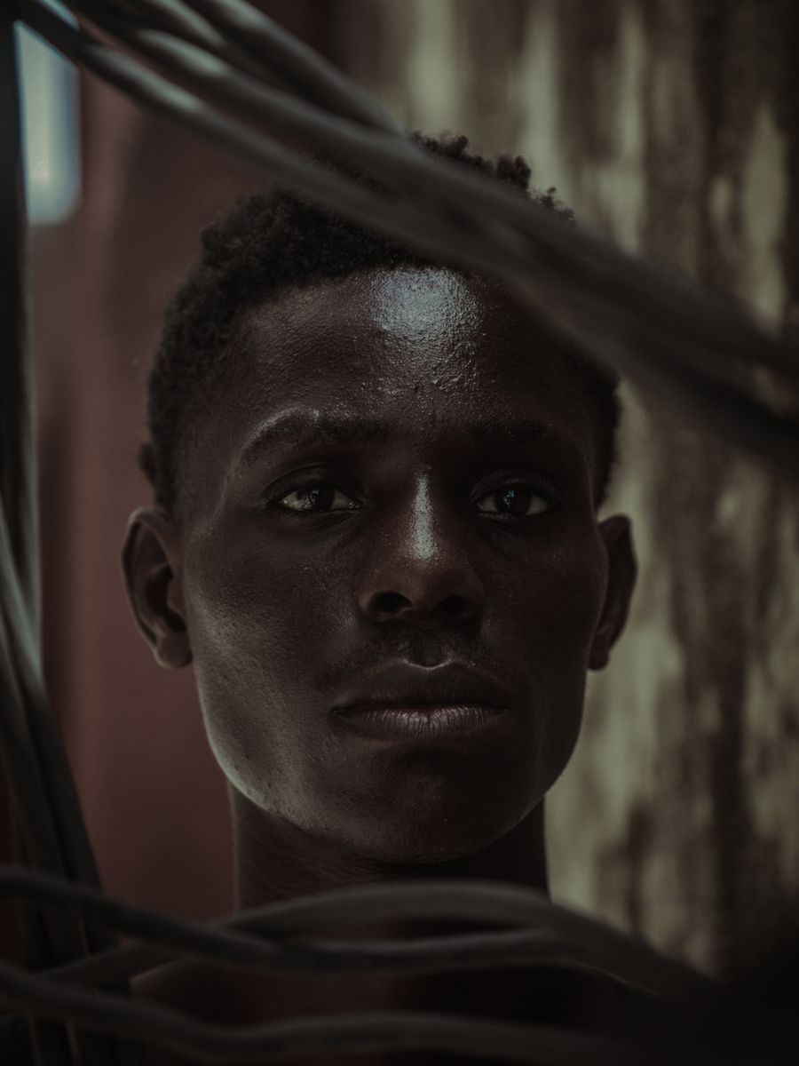 Portrait of a man looking straight into the camera in soft, directional daylight.