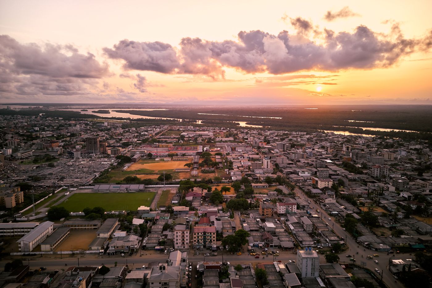 Aerial view of a dense African city stretching to the horizon at sunset.