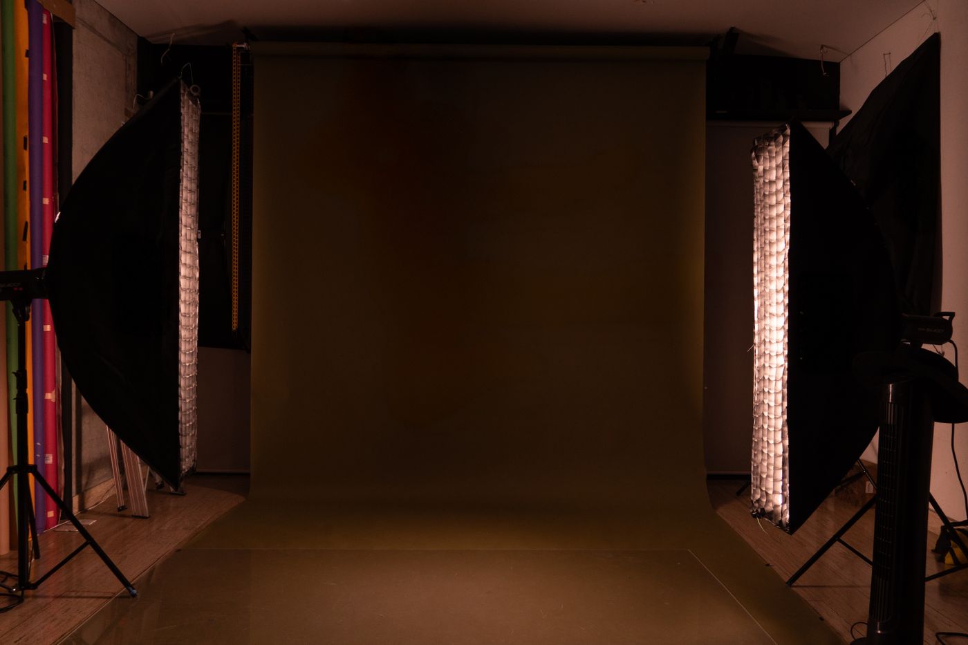 A photography studio set with a seamless backdrop and softboxes rigged either side.